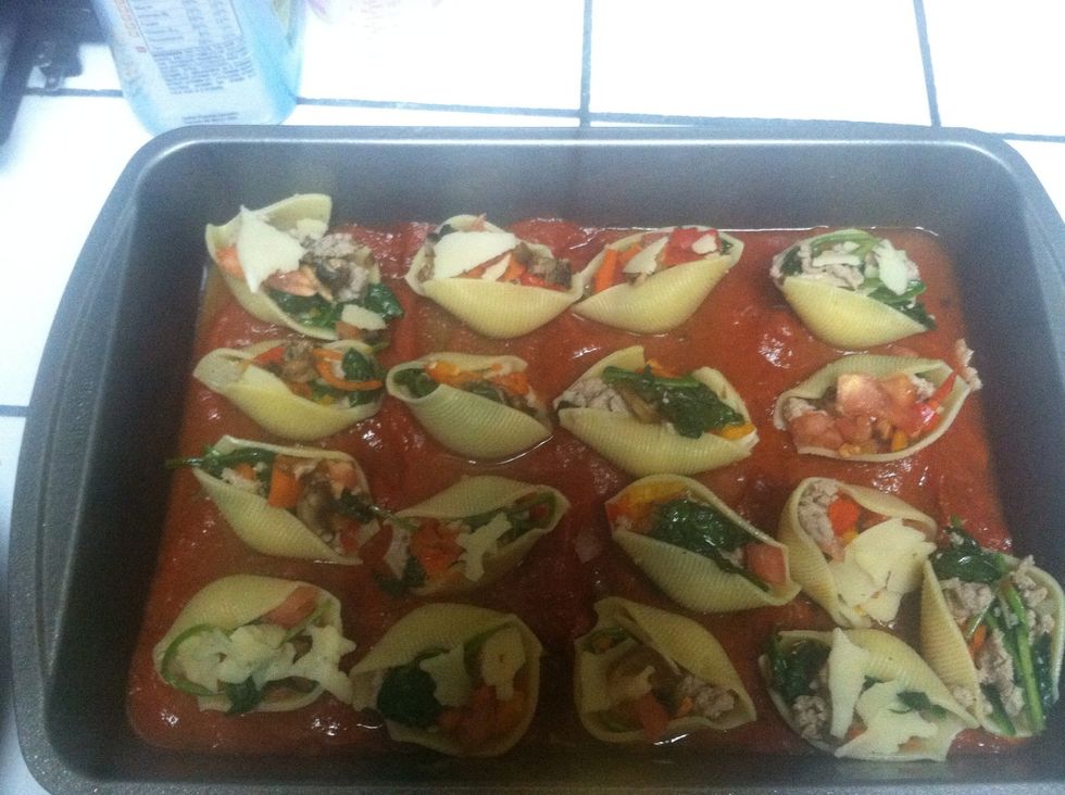 Wala! Pour marinara in a pan with water. You've stuffed your shells with everything and now it's time to stick them in place.