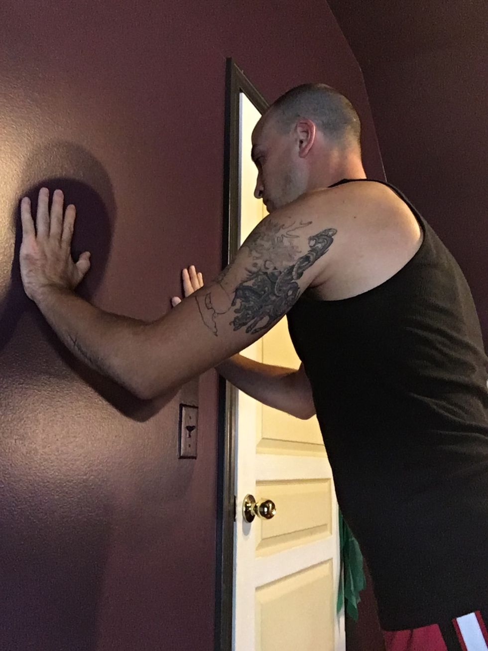 Wall push ups are a great way to incorporate useful movement into your rehab. Keep your back straight and your hands shoulder width apart, feet together.