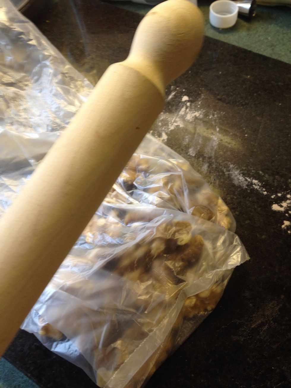 Walnut halves placed in a small sandwich bag and bashed once or twice.