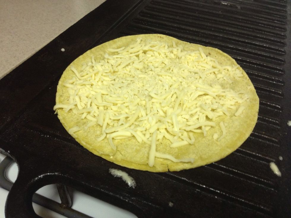 Warm grill at medium heat, then add ingredients in layers. Starting with half of the cheese.