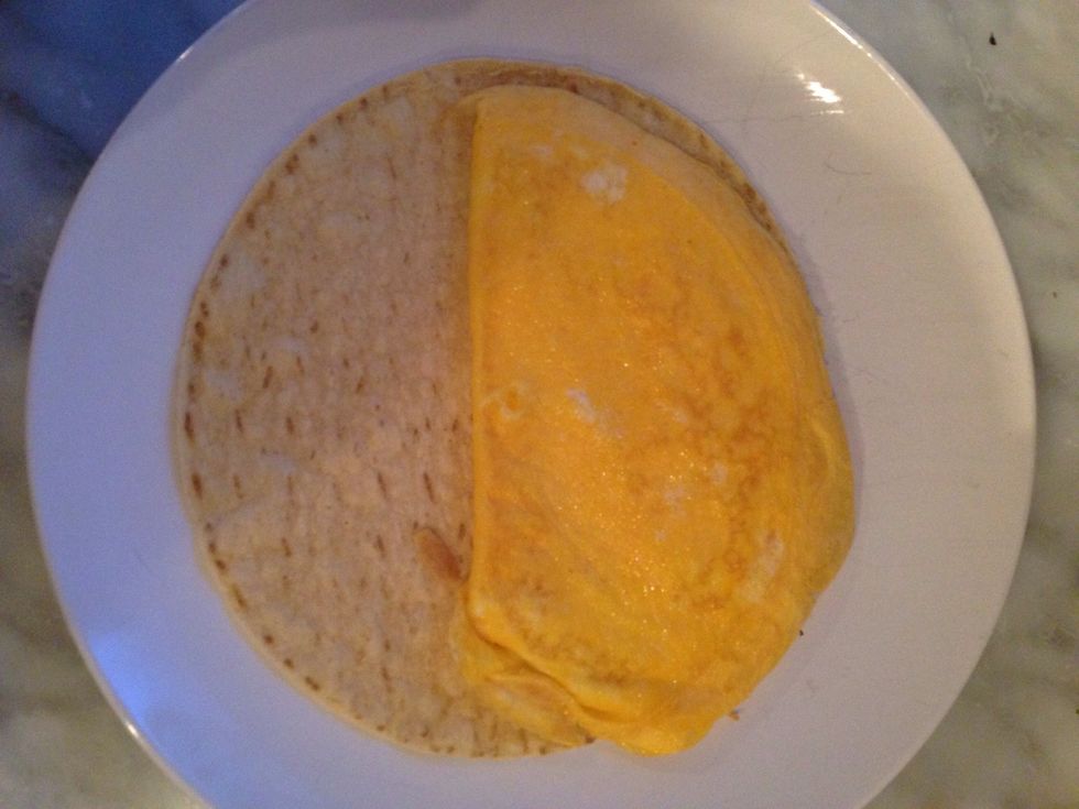 Warm the corn tortilla in the microwave for 5 seconds so it become more flexible. Then add the egg on top