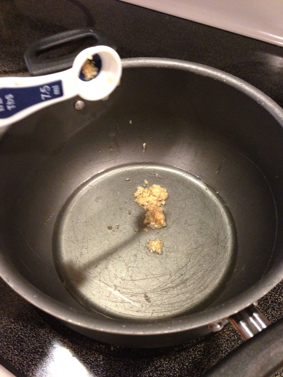 Warm up oil in large pot and saut\u00e9 garlic.