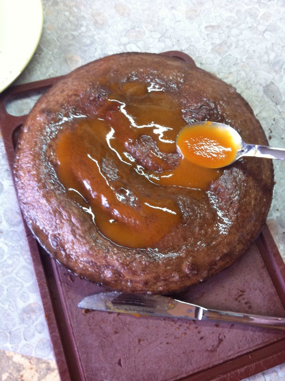 Warm up the rest of apricot jam and spread it on the top and all around the cake.