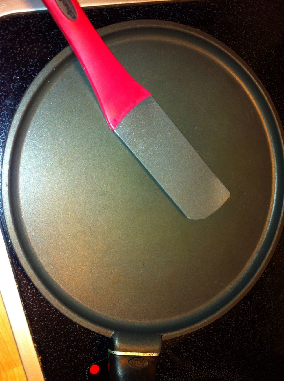 Warm your crepe pan or any fry pan. Start on medium-high and adjust the heat if needed. Because of the butter in the mixture, you shouldn't need to add any fat to the pan.