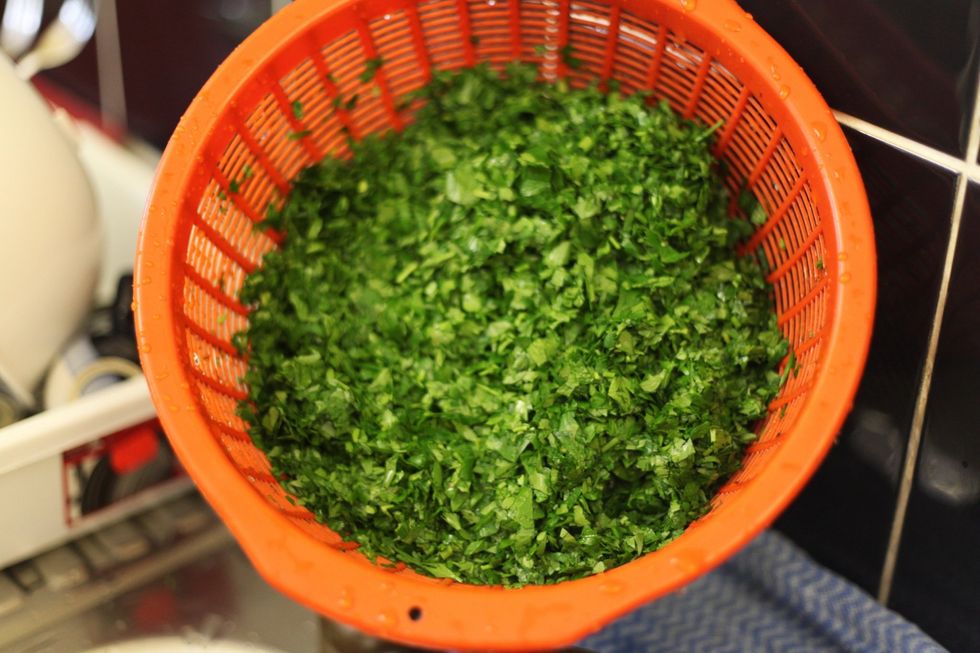 Wash 2 large bunches of parsley and chop finely and set aside to drain the water out. Chop as fine as you can go without turning it into a paste. Lol.