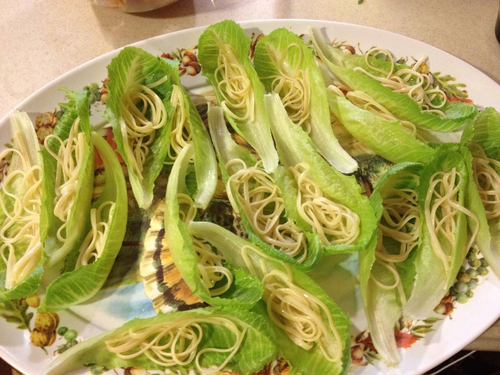 Wash and arrange lettuce leaves and prepare noodles as you normally would. Layer them on lettuce.