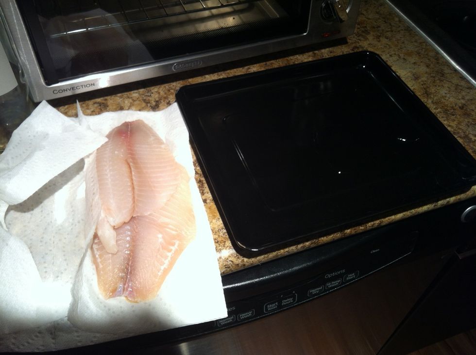 Wash and dry tilapia. Prepare baking pan with olive oil coating.