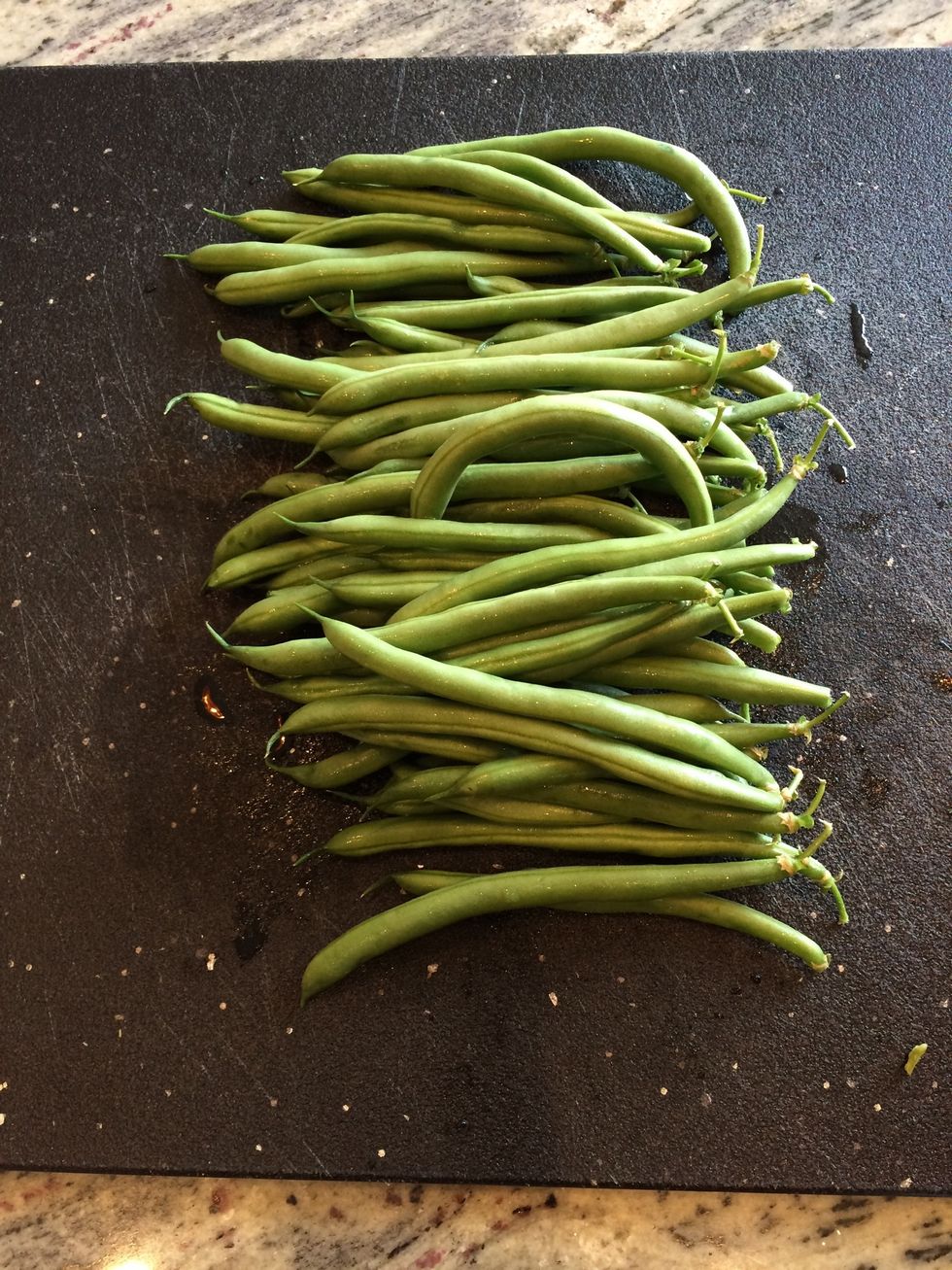 Wash and line up the string beans with tops facing right and tails left.