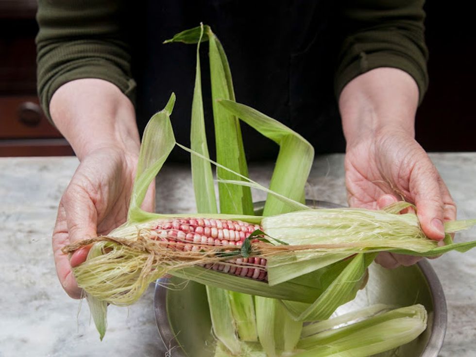 Wash and shuck the whole ears of corn.