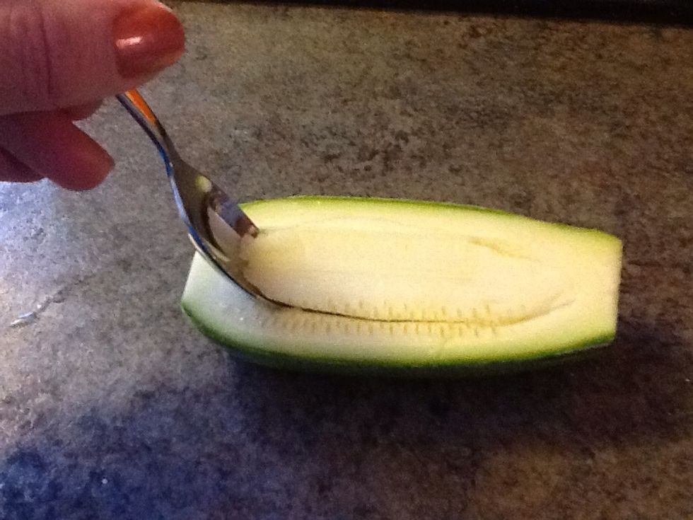 Wash and slice Kusa length wise, take a knife and carve out centers. With a spoon scoop out middle, including seeds....the idea is to make a "boat".