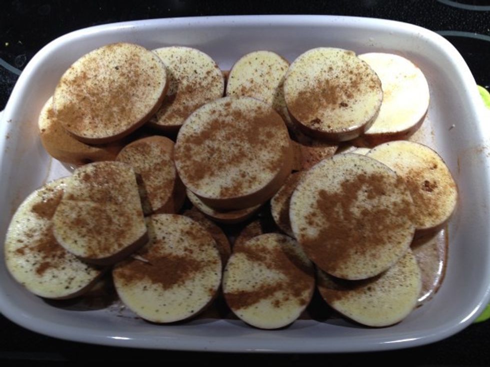 Wash and slice sweet potatoes in rounds and put down a layer in a casserole. Grind on Salt, Pepper, and sprinkle on ground cinnamon. Add more layers and salt and pepper and cinnamon for each layer.