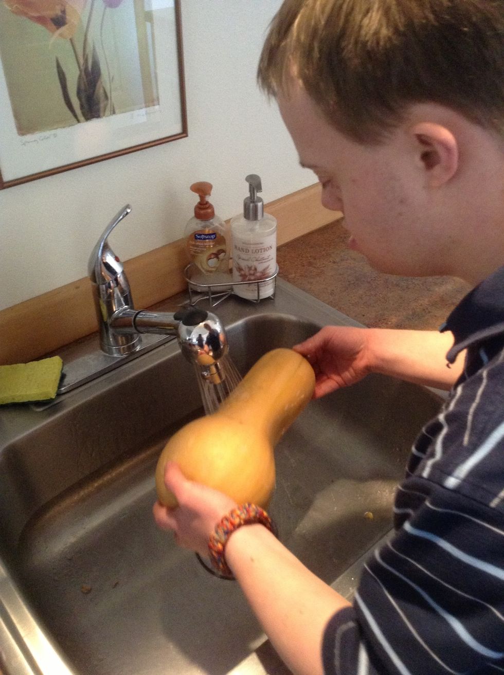 Wash butternut squash in kitchen sink