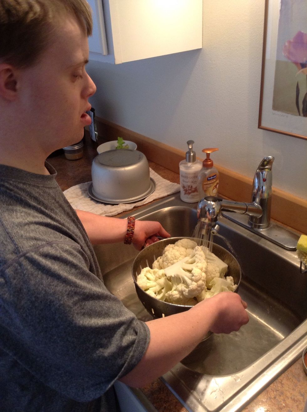 Wash cauliflower in kitchen sink
