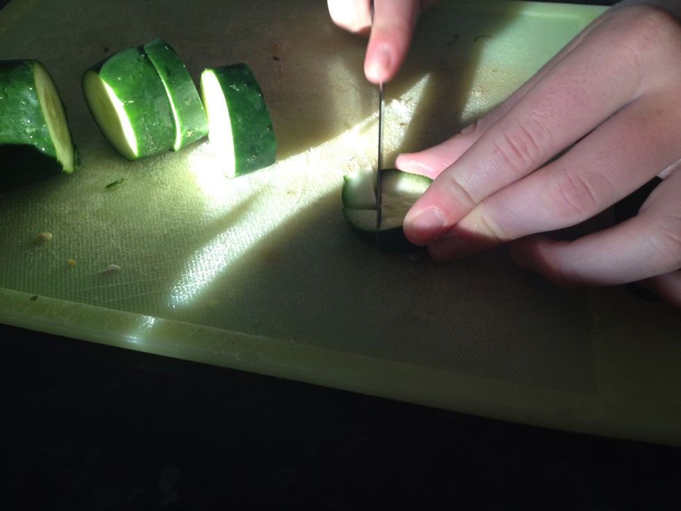 Wash cucumber. Cut off end, them dice them into cubes. Place into bowl.