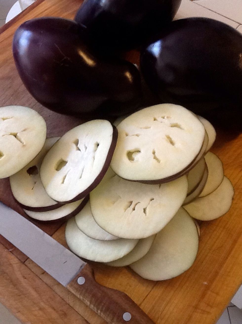 Wash eggplants for good measure, and slice into 1/2 inch thick rounds. Some folks like to wash the slices and give them a salt bath sweat to try and take out the bitterness. I leave that to you.