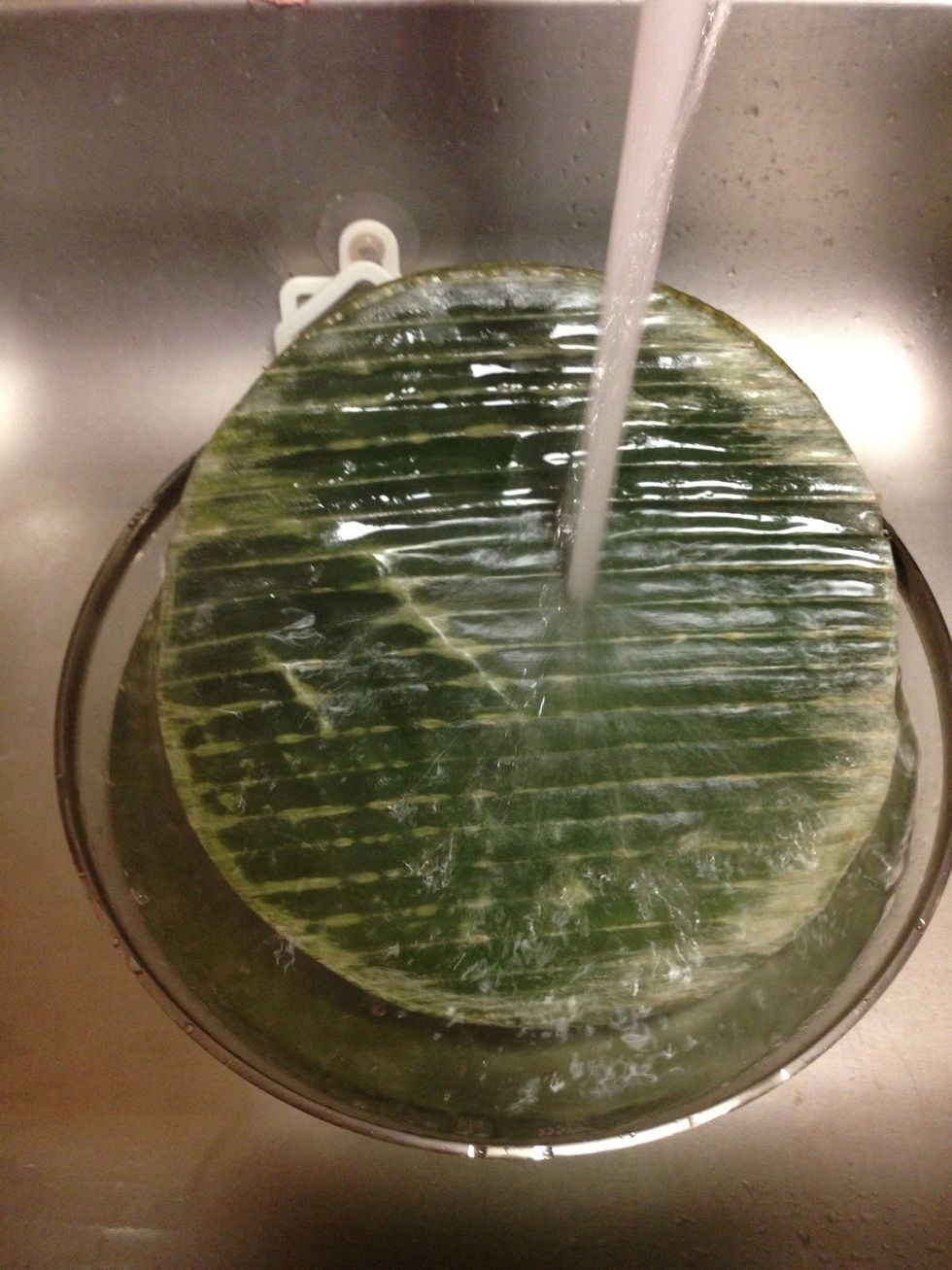 Wash frozen banana leaves with hot water