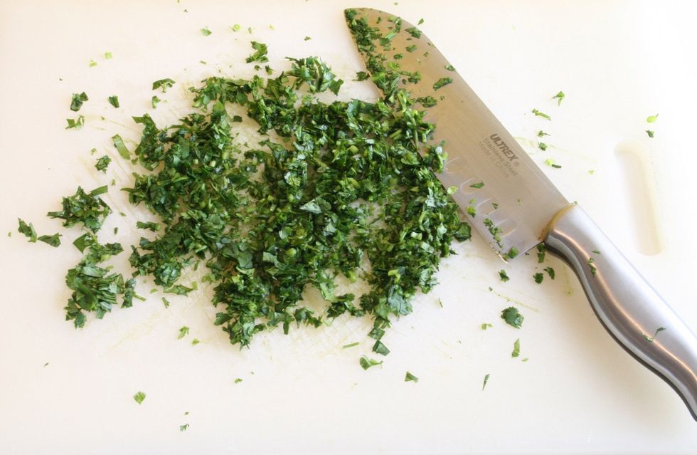 (Wash it) Cut the cilantro on the cutting board.