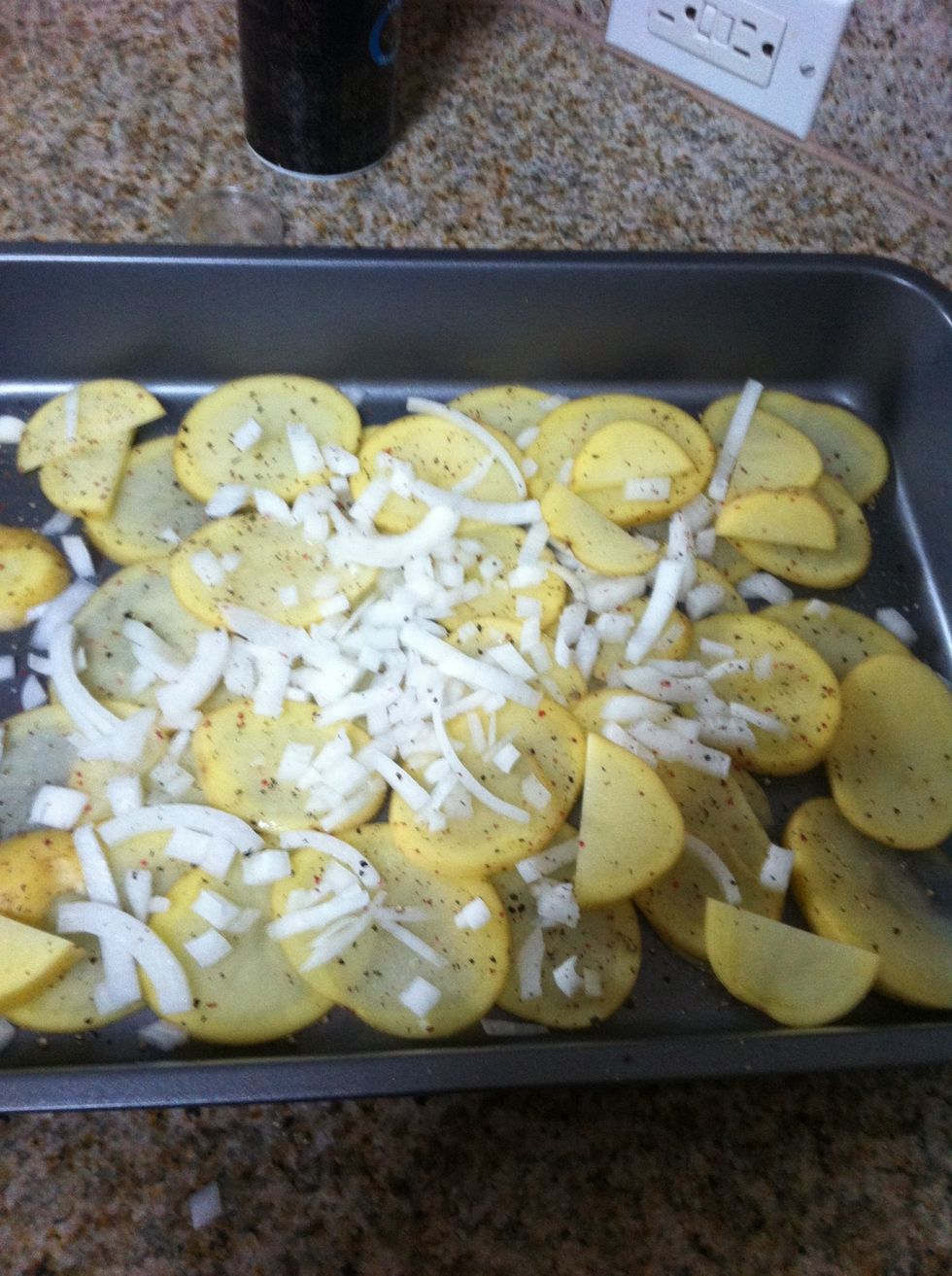 Wash, rinse and thinly slice your potatoes and toss on the cut up onion on a baking tray. No need to get fancy here...just finish with some salt and pepper.