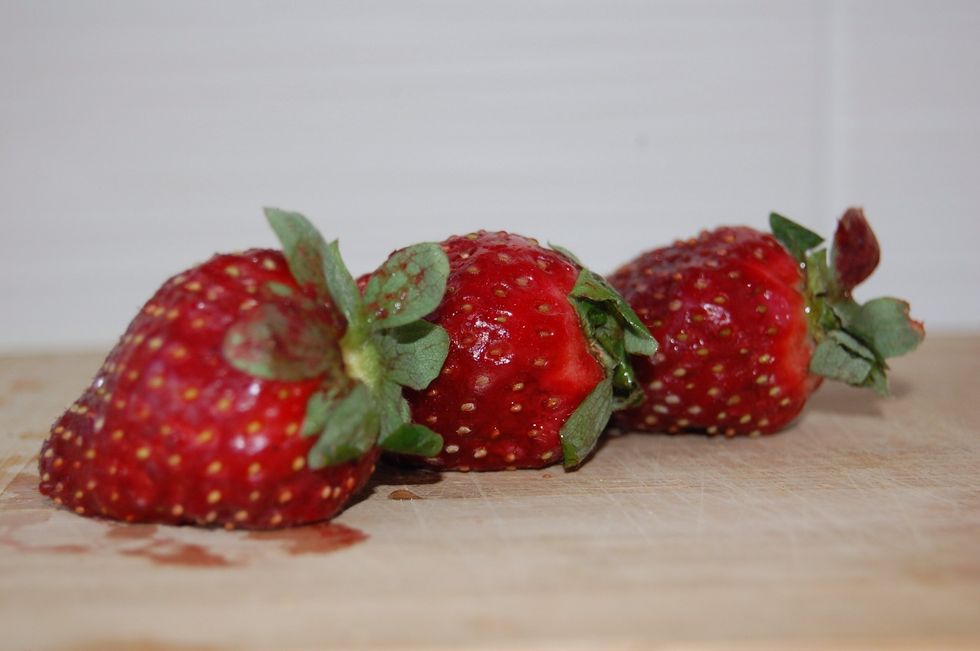 Wash, seed, and chop 3 fresh strawberries.