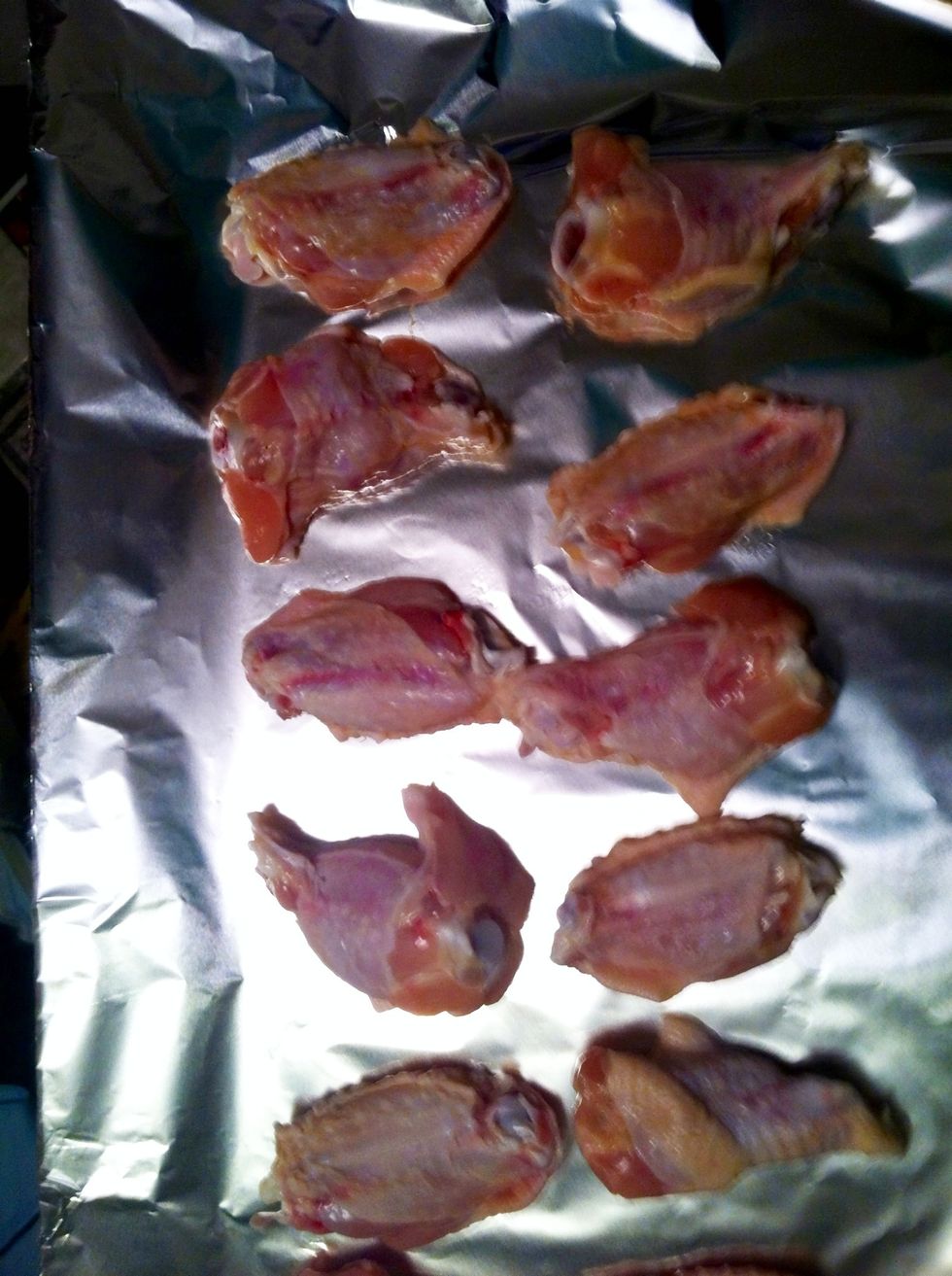 Wash some chicken wings and pat dry . Place on a sheet of foil.