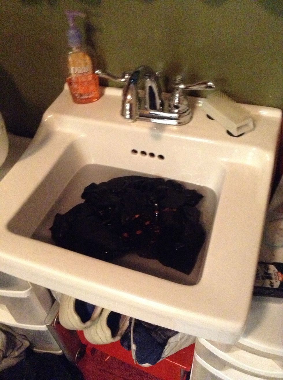 Wash that son of a gun. You could toss it in your washer as you would normally wash clothes, but I scrubbed it in a sink filled with warm water and a TINY bit of distilled vinegar. Just knead it up!