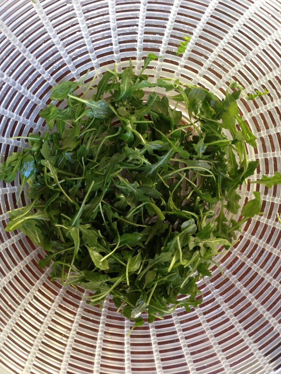 Wash the greens and dry them in a salad spinner. I like using spicy greens like arugula and watercress. Pictured: arugula.