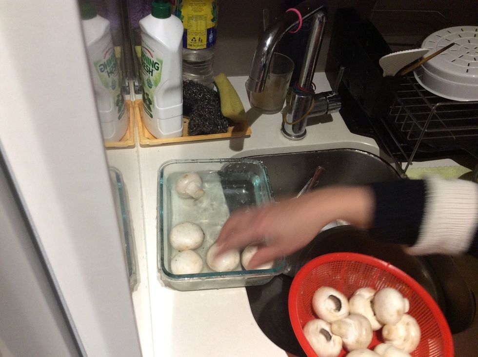 Wash the mushrooms by putting them in a bowl full of clean water.