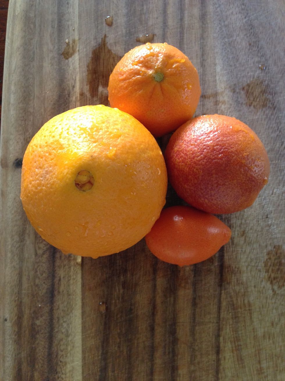 Wash the oranges with a brush. It's always a good idea to wash fruits even if you are discarding the peel. Pictured: Cara Cara, mandarin-quat, Moro blood orange, and mandarin.