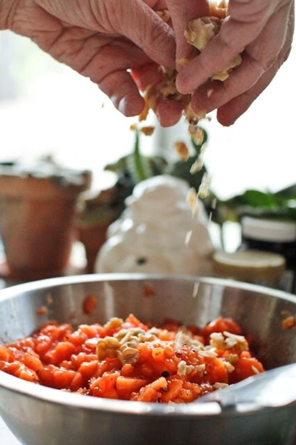 Wash the papaya then peel it and scoop out the seeds. Chop the papaya into small pieces. Toss in the chopped nuts and mix them in well.