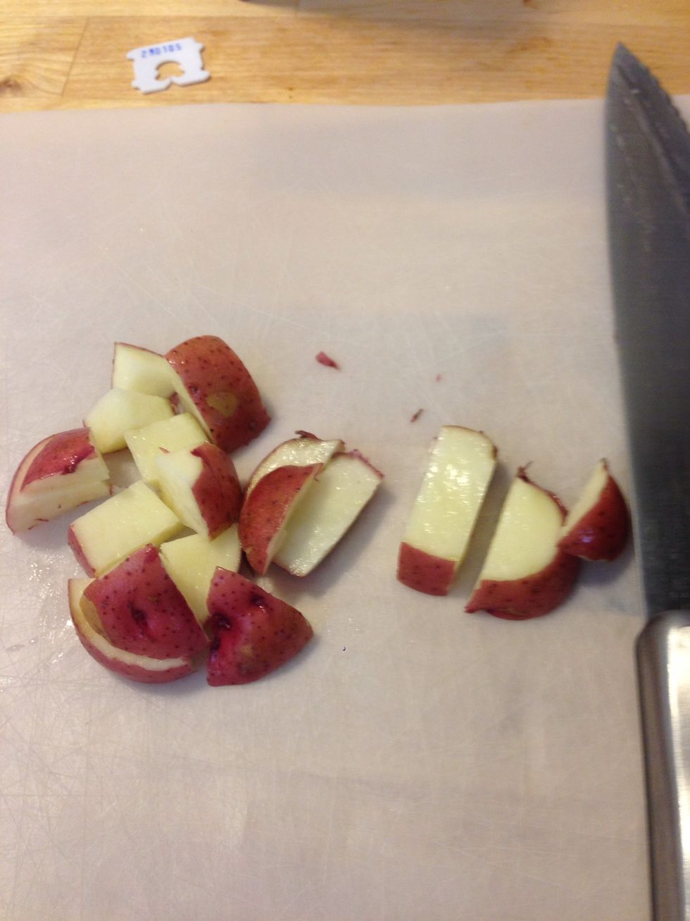 Wash the potatoes and chop them into cubes.