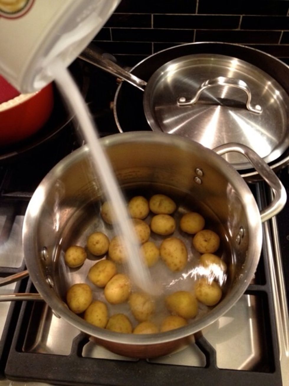 Wash the potatoes and put it in the pot with water. Start pouring the salt