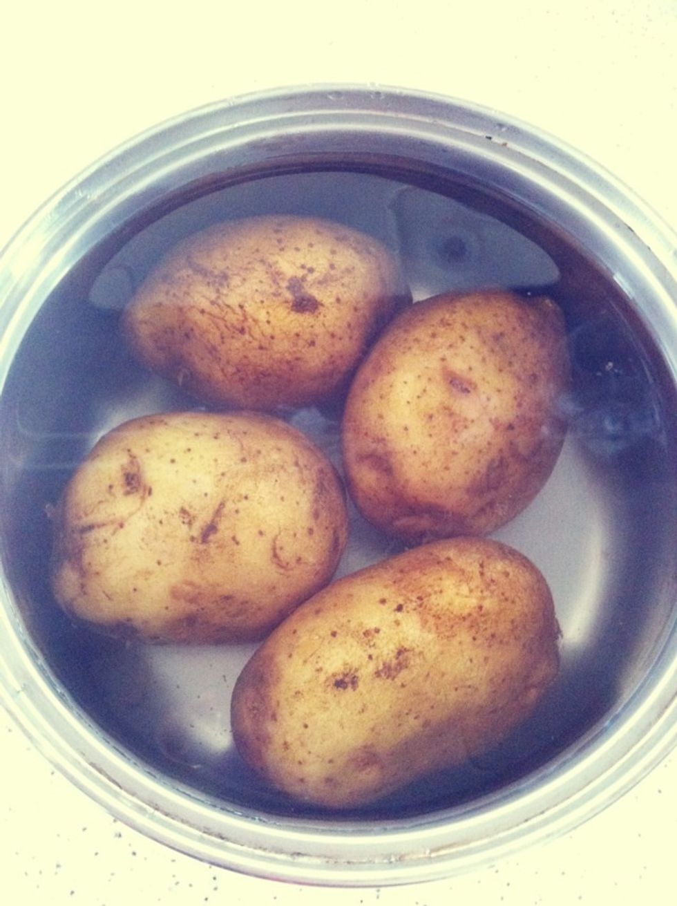 Wash the potatoes, put them into a pot of boiling water & cook till soft. Potato is ready when a chopstick can be easily poked through.