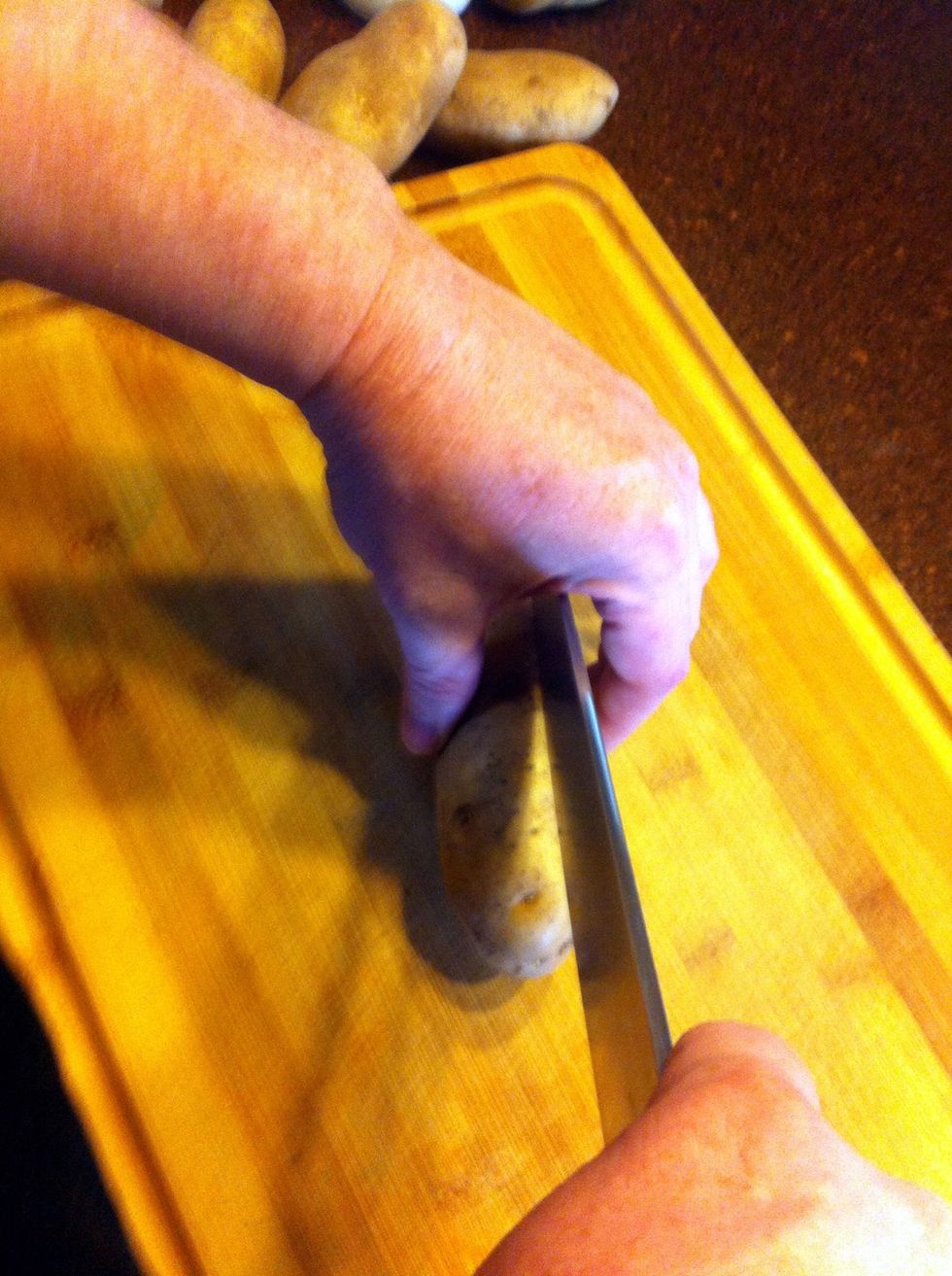 Wash the potatoes, then cut them into strips