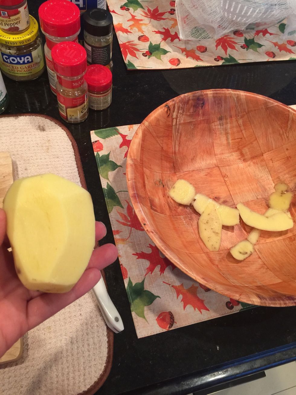 Wash the potatoes then peel the potatoes.