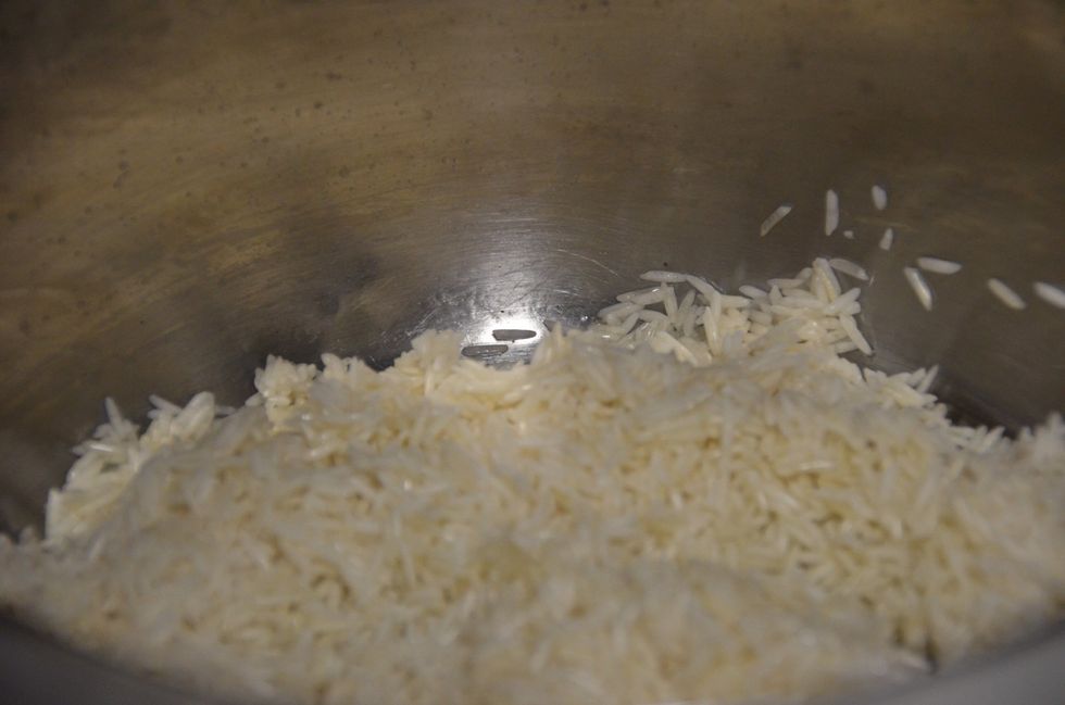 Wash the rice with cold water and drain. Heat olive oil on a medium heat and add the rice.. Saut\u00e9 for 7-8 mins until its golden brown. Keep stirring.