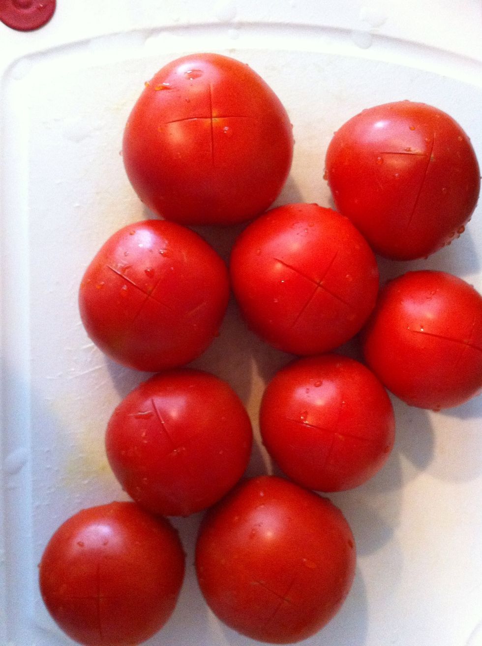 Wash the tomatoes and cut X on the back of each tomato