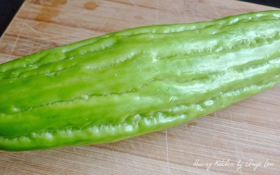 Wash well a medium size bitter gourd. It's best to choose those bitter gourd with wide pattern lines in between and are light pale green in colour as these won't be too bitter for the soup.