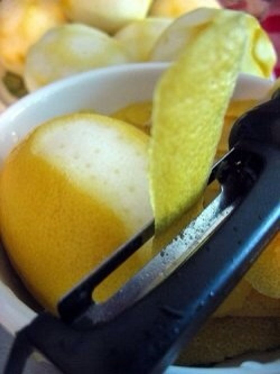 Wash your lemons in warm water and scrub to remove any wax.  Remove the peel with a very sharp peeler or knife, being careful to remove only the yellow part of the lemon.