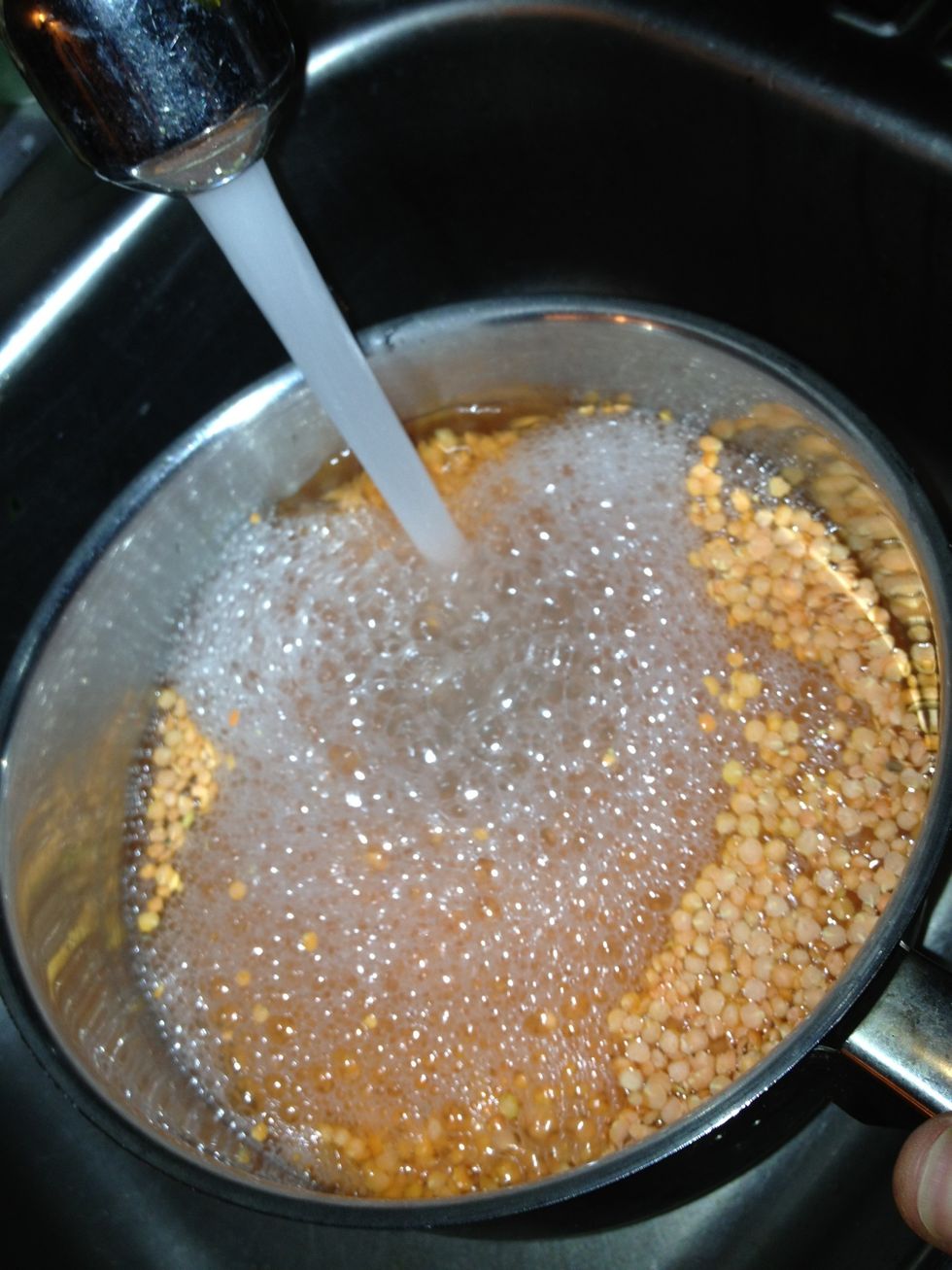 Wash your lentils in a separate pan, use cold water, drain. Do until the water runs relatively clear.