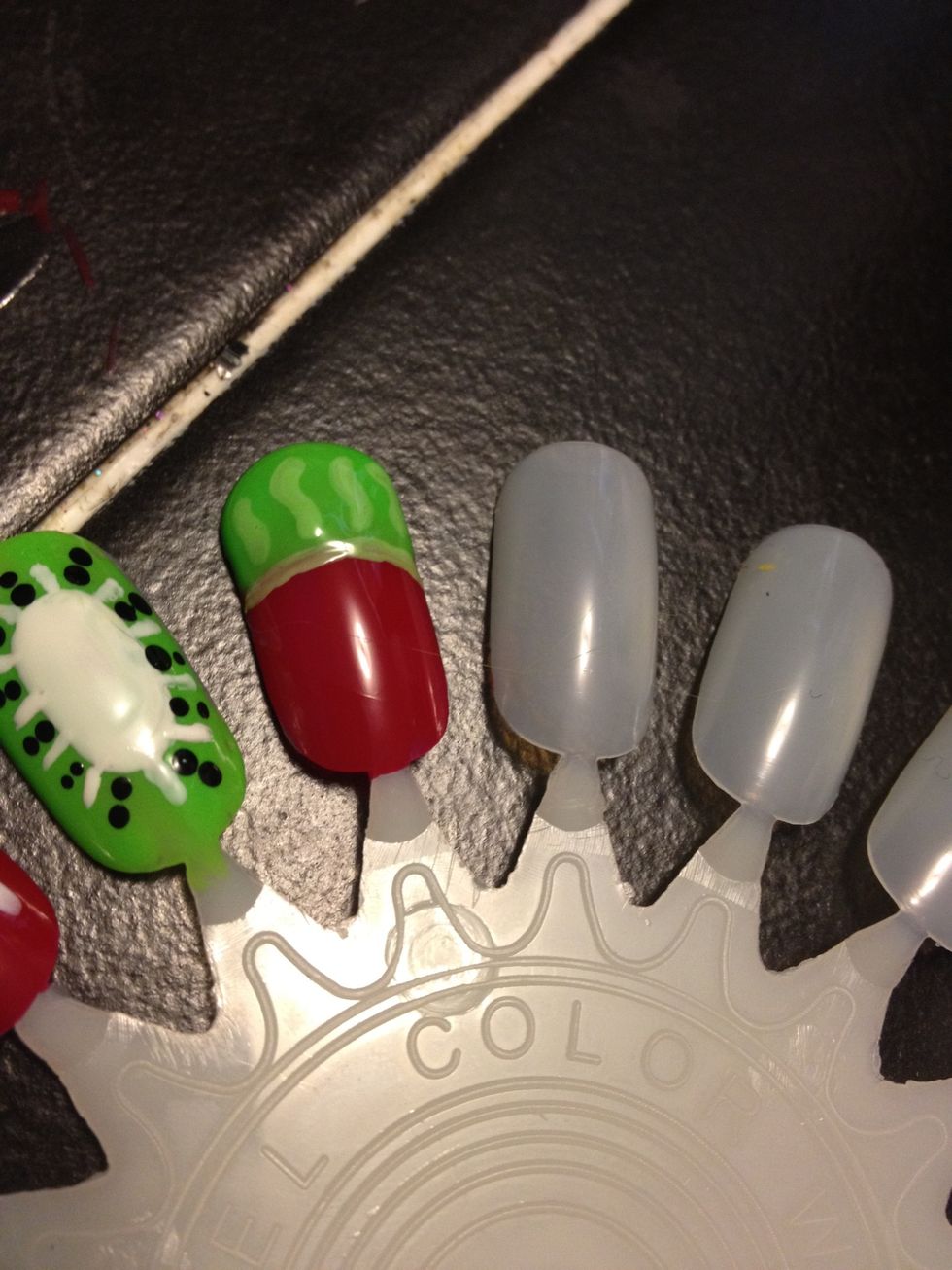 Watermelon. Red base coat, and a green tip. Outline the tip with a lighter green polish, and make light green squiggles in the tip.