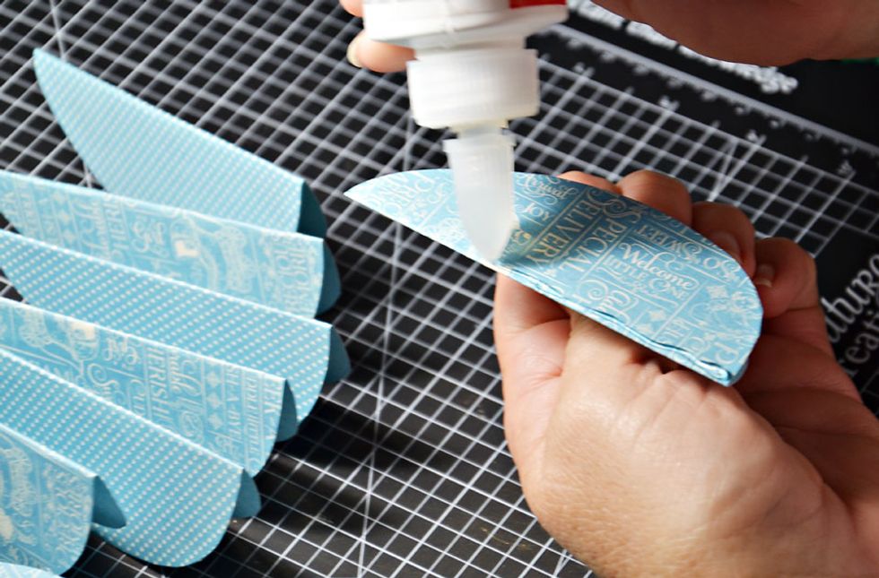 We are creating 2 halves of the egg, so you will need to glue 6 together as shown, then repeat the process with the other 6. PLEASE NOTE - only glue along the folded edge only.