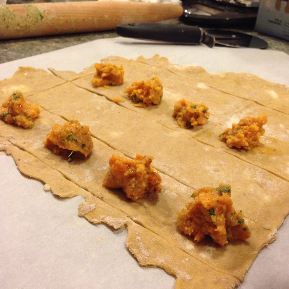 We are going to be folding the dough over to make the second half of the ravioli so don't forget to space the filling out!