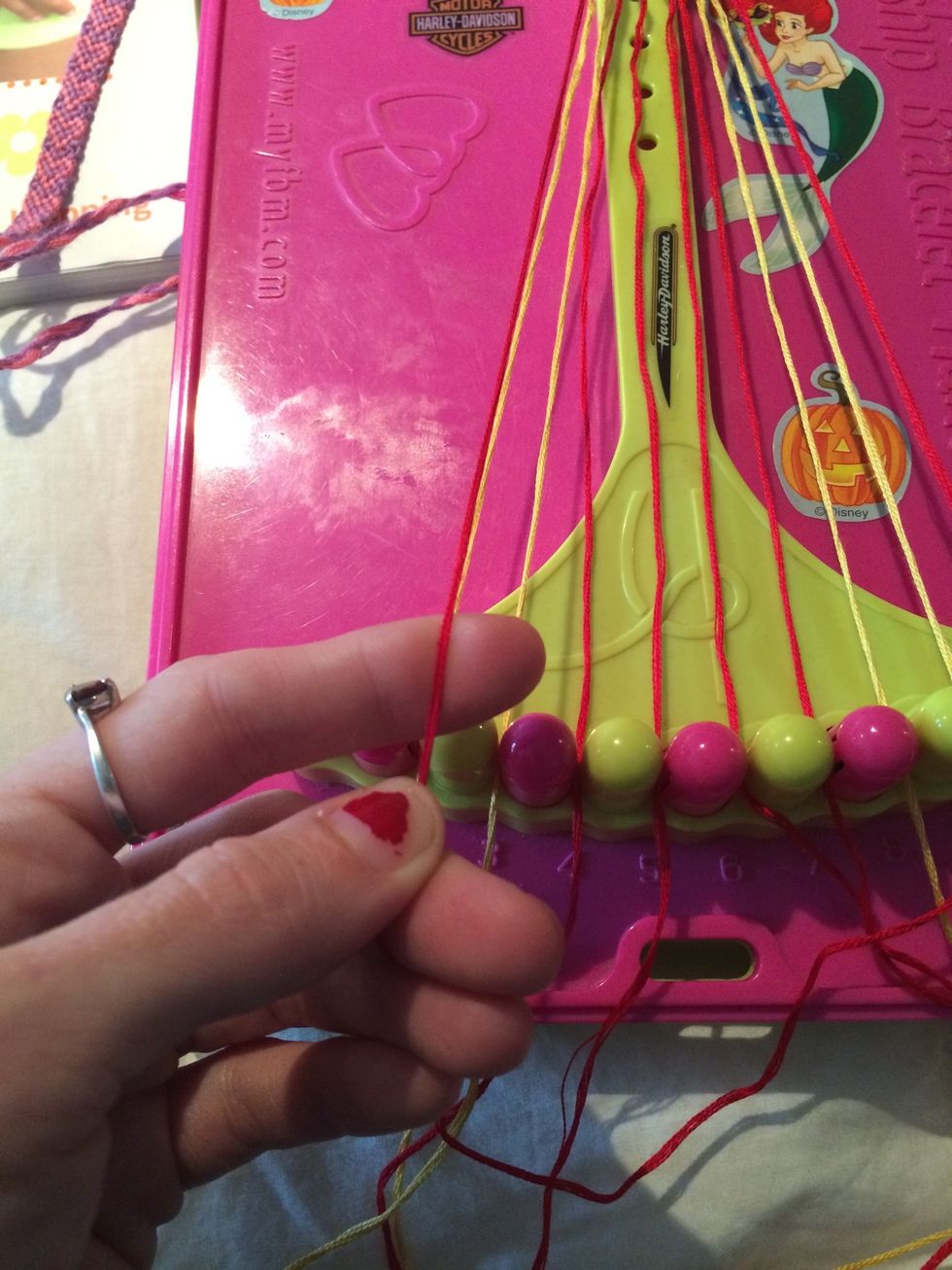 We are going to start with the left side since we just ended here. This this row was Backwards to start now we are going Forwards. Pick up the first red string and make your way across the others.