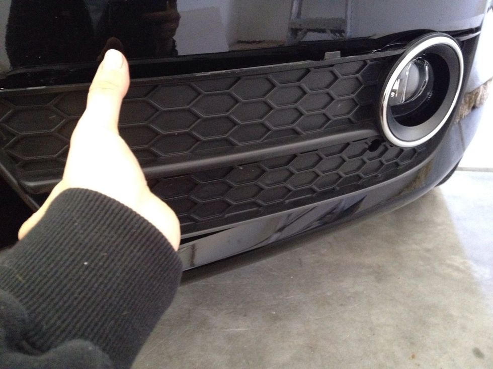 We are now done adjusting so we can place the fog light panel back on. Easiest way is to get the outer-right clips in first, then the middle, and finally the inner-left clips.