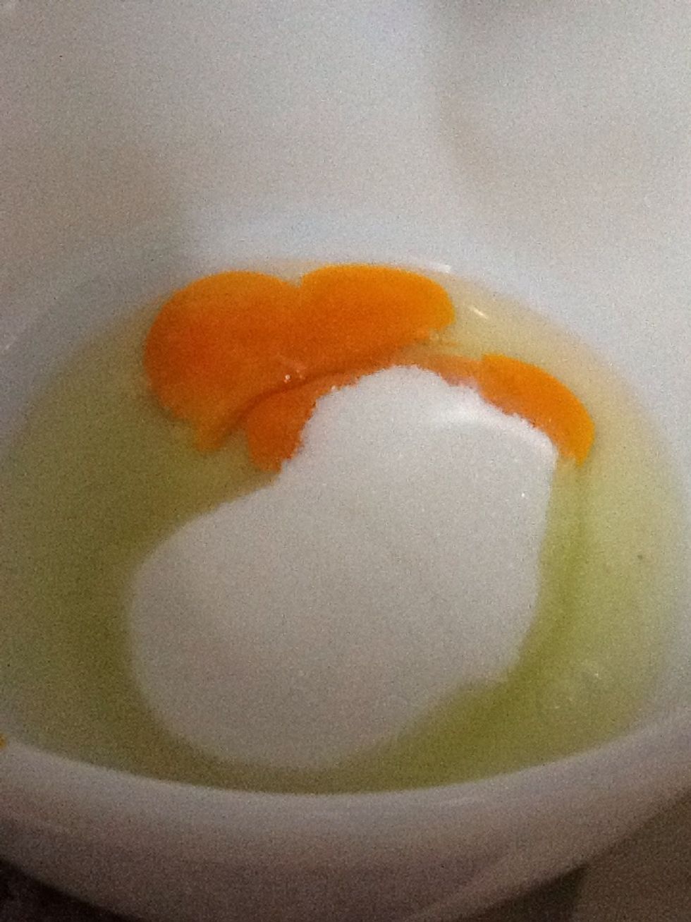We crack x2 eggs and pure in 1/2 cup in of sugar. Then you have to stir it so that those ingredient combined really well.