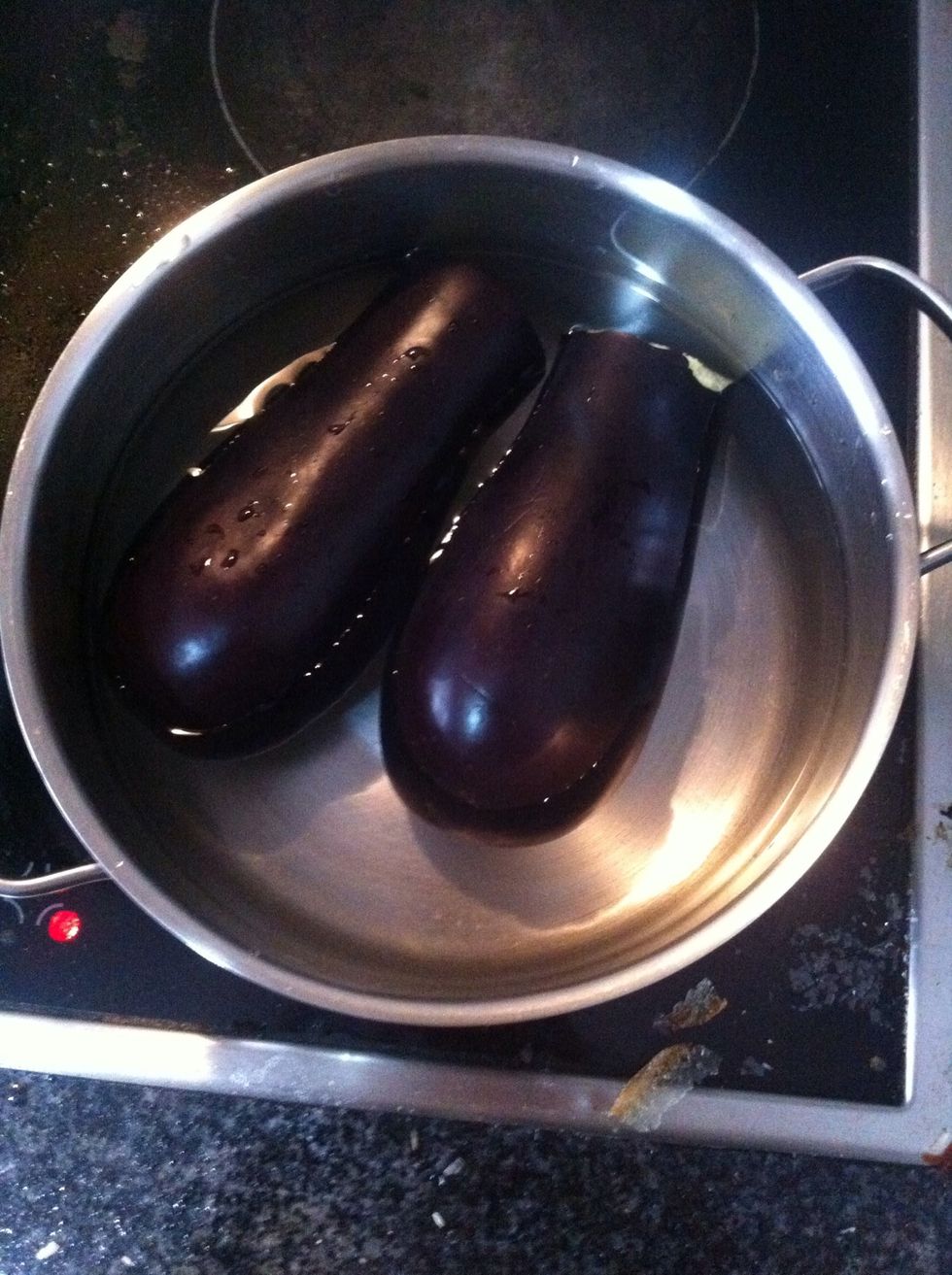 We cut the eggplant in two halves and we place them in a pan in hot water until their flesh gets soft