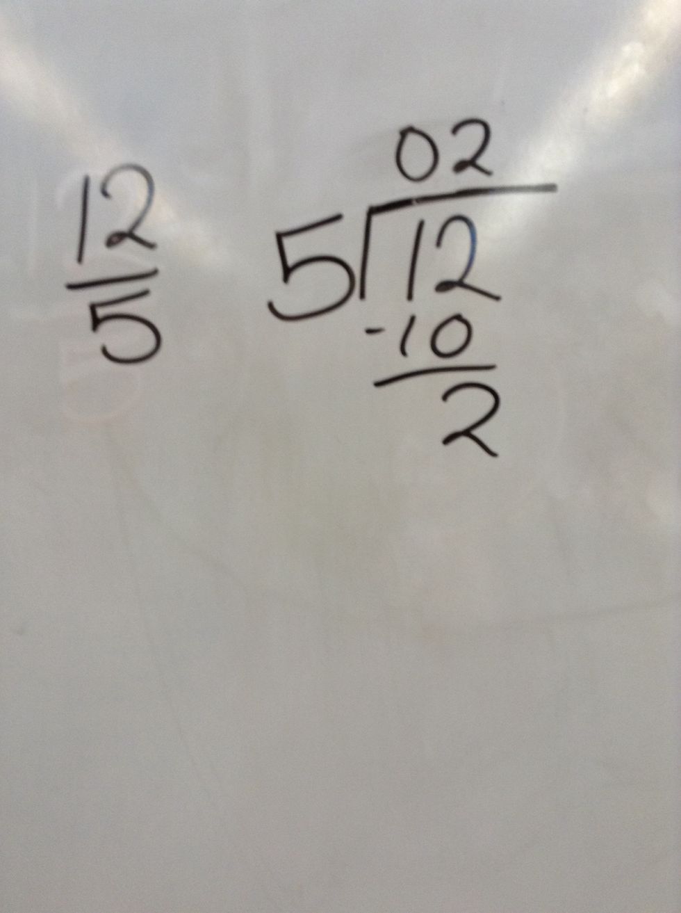 We divided 12 by 5 and 5 can go into 12 two times and that is 10 so   we did 12-10= 2.