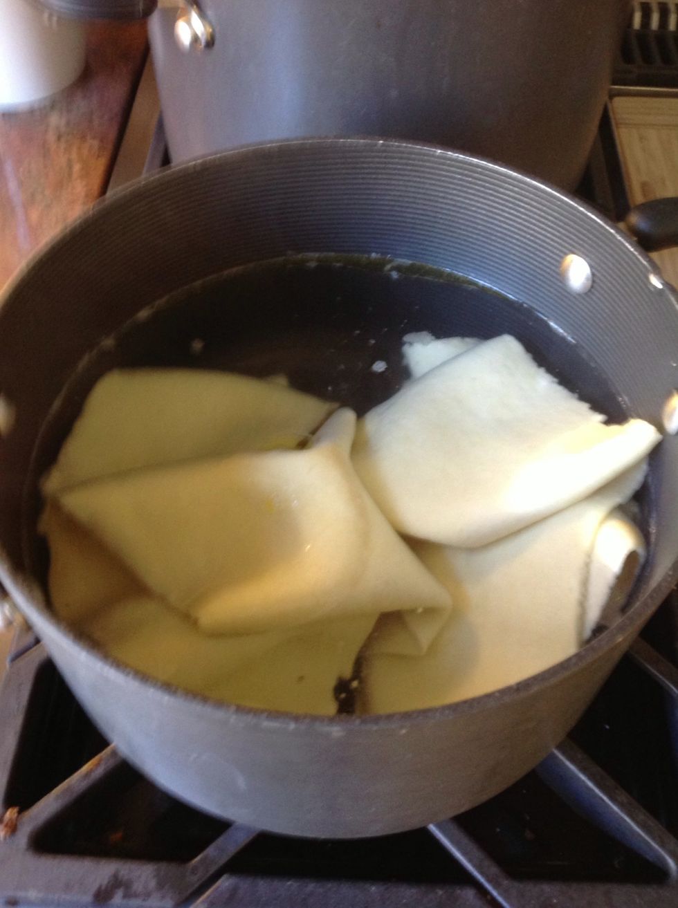 We do four pasta sheets at a time. It takes less than 2 minutes for them to cook. Tongs work best for getting them out. Make sure to add salt to your water and Olive oil so they don't stick.