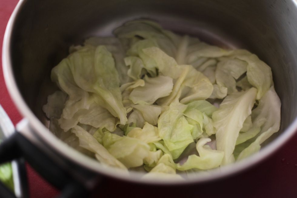We don't waste anything. With the hard bits and pieces you can't roll, use them as your first layer. It protects the next layer of cabbage rolls from burning.