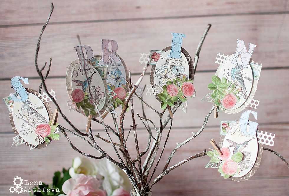 We fix the ovals to the branches with little pins.